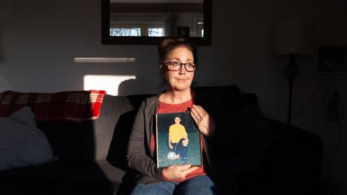 Andrea Zack sits for a portrait with a picture of her son, James Pschirer, at her home in McCandless, Pennsylvania on Thursday, Feb. 25, 2021.